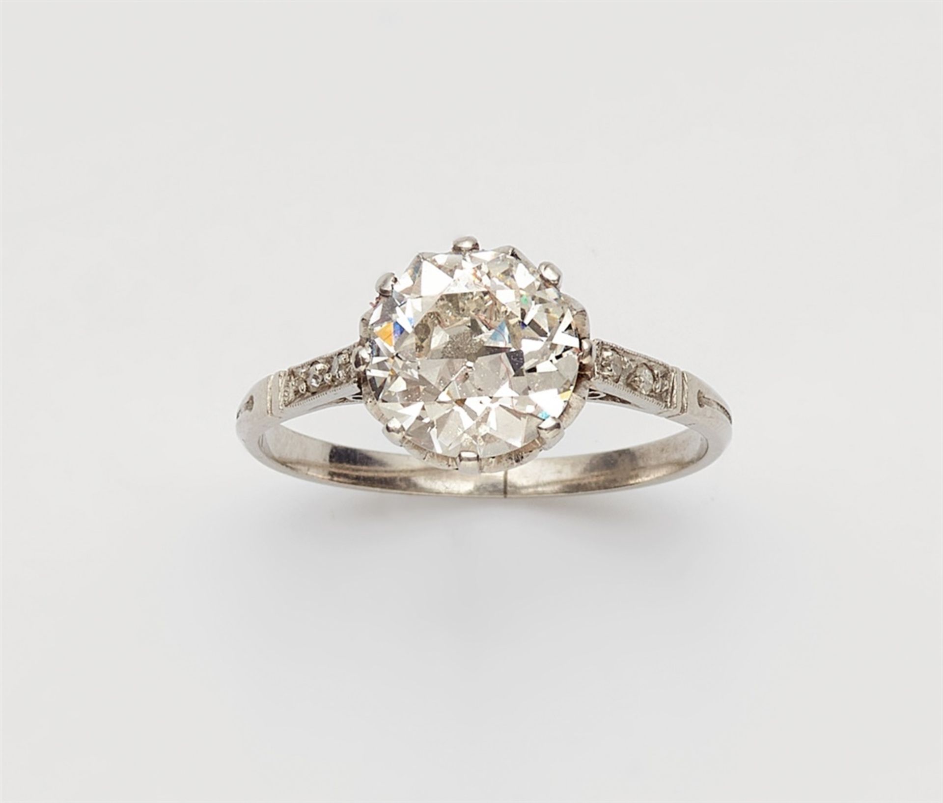 An 18k gold Belle Epoque ring with a diamond solitaireThe shoulders set with four 8/8-cut