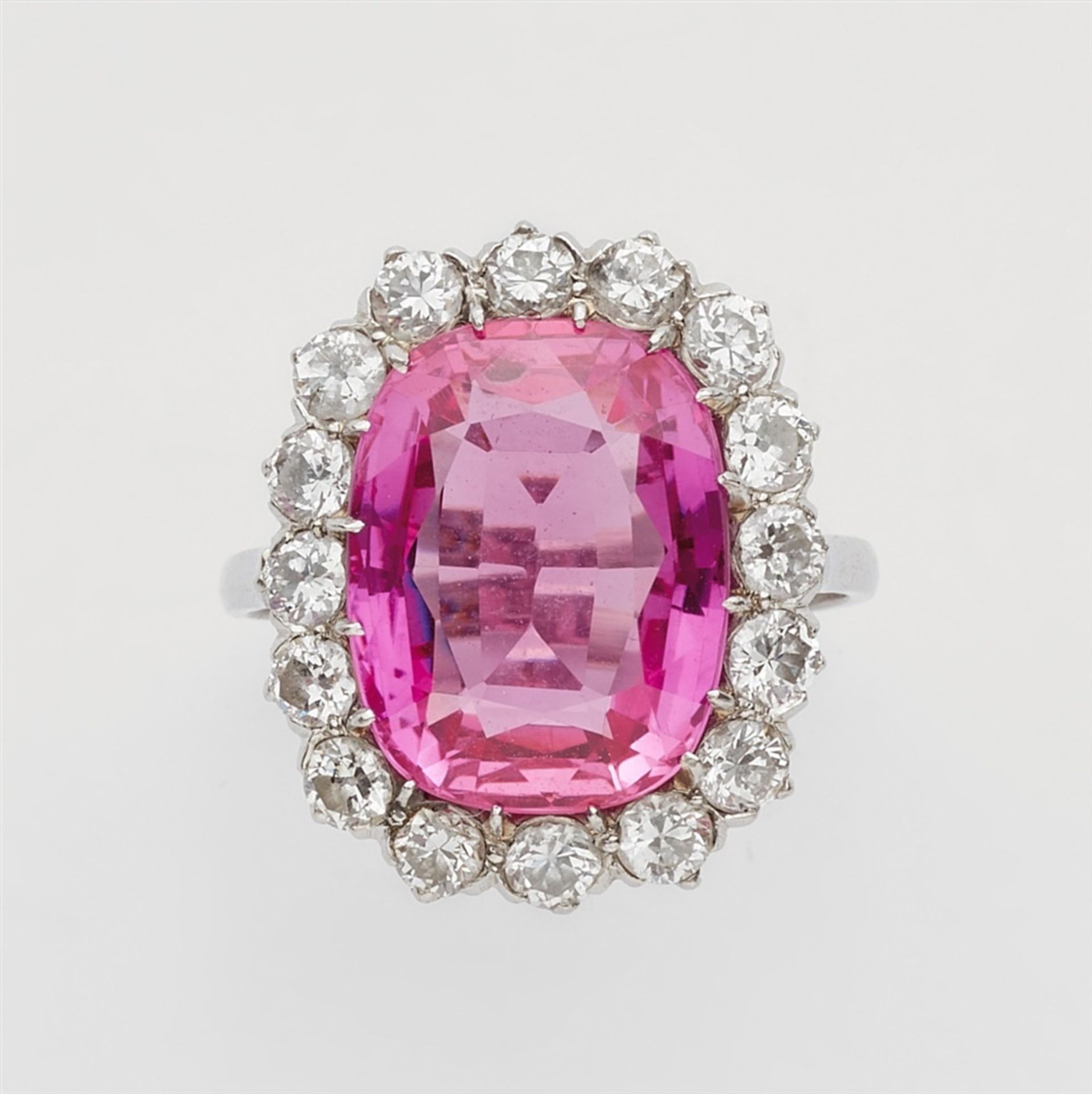 A platinum cocktail ring with a pink Verneuil sapphireSet with a central pink synthetic sapphire (c.