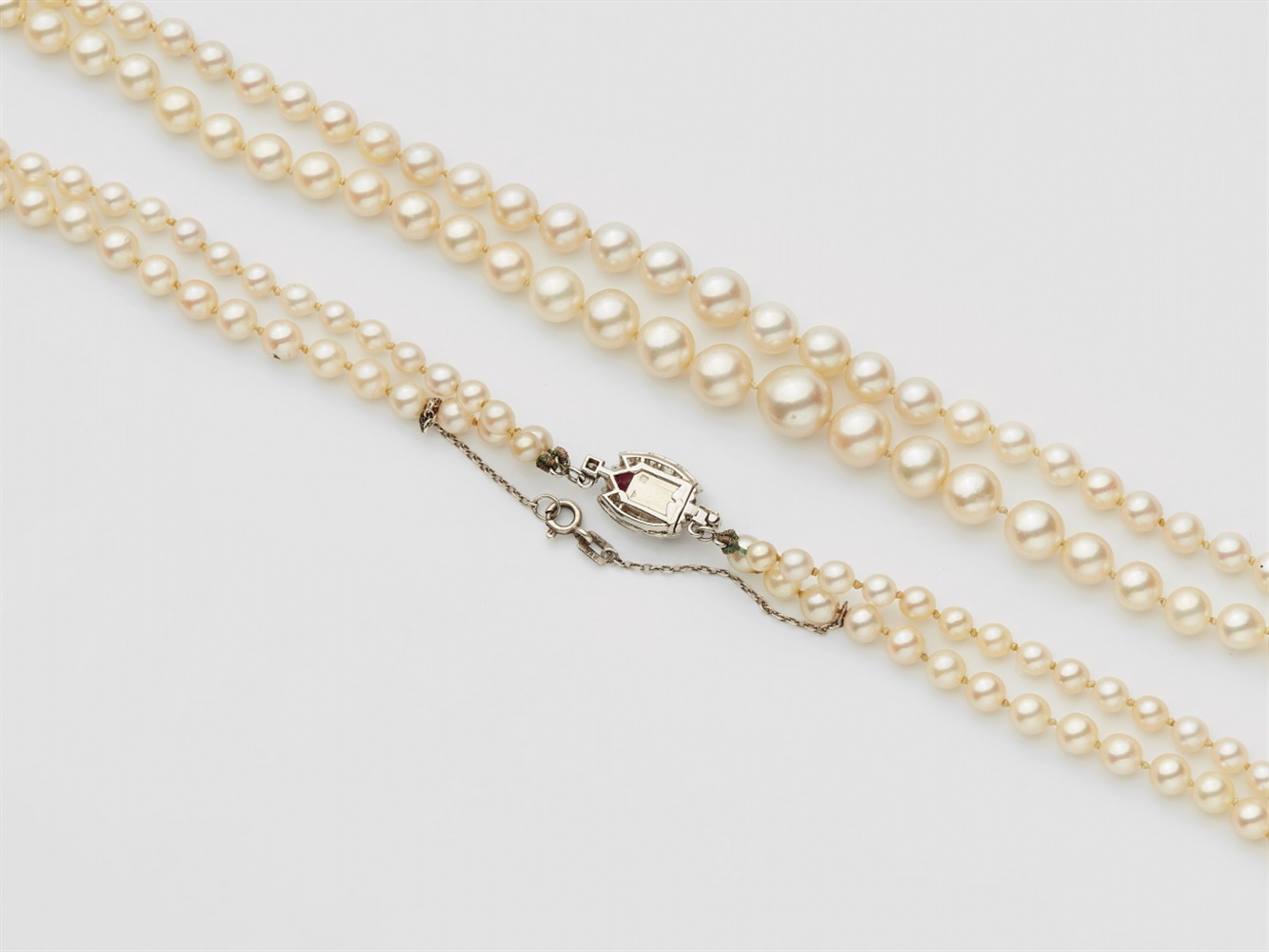 A French pearl necklace with a diamond and rubelite claspA two-stranded pearl necklace comprised - Image 2 of 3