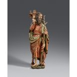 A late 15th century Bavarian carved limewood figure of Saint ChristopherCarved three-quarters in the