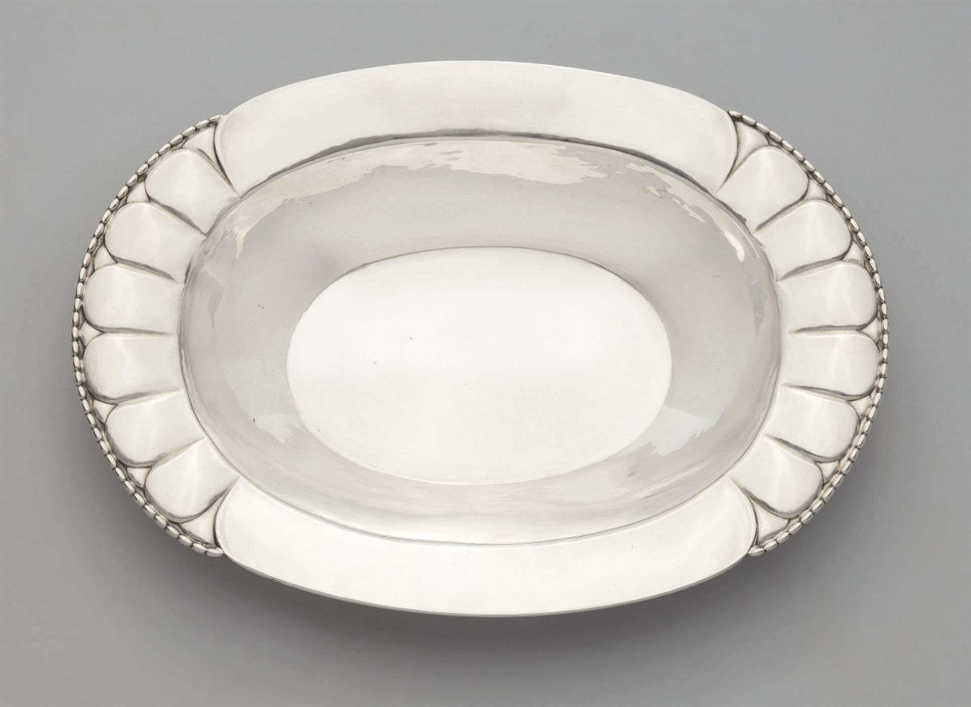 A silver sweetmeats dish by Georg Jensen, model no. 3Silber. A deep oval dish with partially