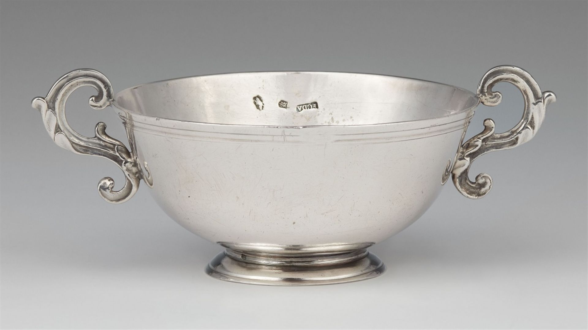 A Mexican silver bowlSlightly flaring bowl with scroll handles. Diameter without handles 11.5 cm,