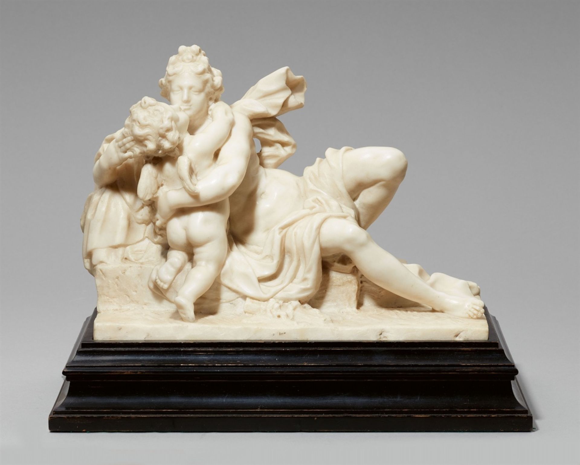 A white marble group of Venus and CupidOn an ebonised wood base. Venus is depicted with long flowing