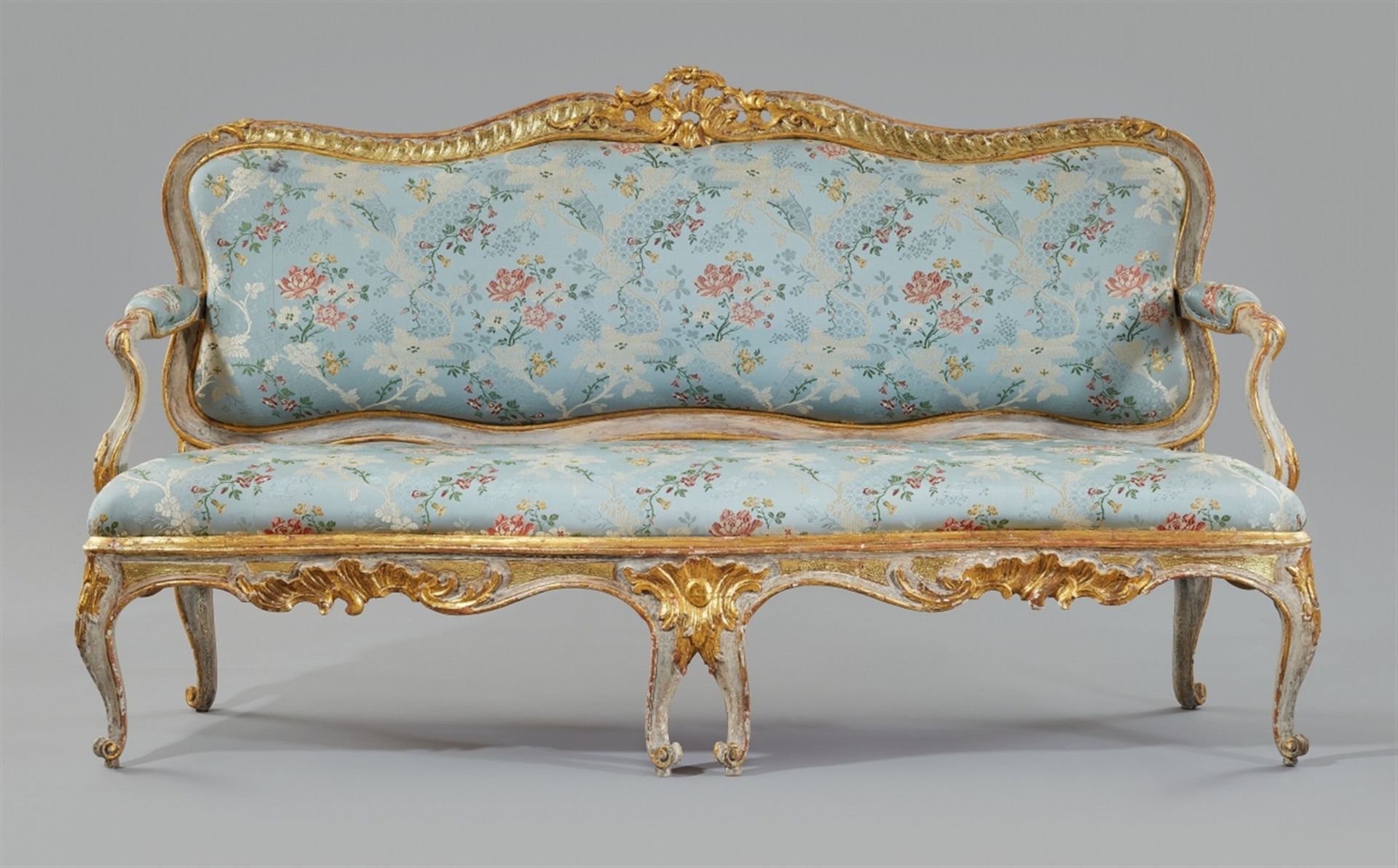 A Rococo canapéWhite and gilt softwood, replaced silk covers over upholstery. Designed to be