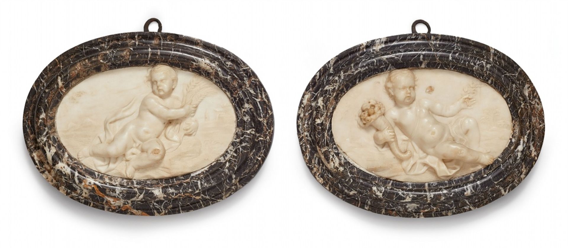 A pair of relief plaques with allegories of spring and summerWhite Carrara marble oval plaques in