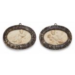 A pair of relief plaques with allegories of spring and summerWhite Carrara marble oval plaques in