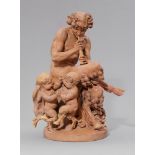 A terracotta group with a faun playing the fluteThree-figure group on a round plinth depicting a