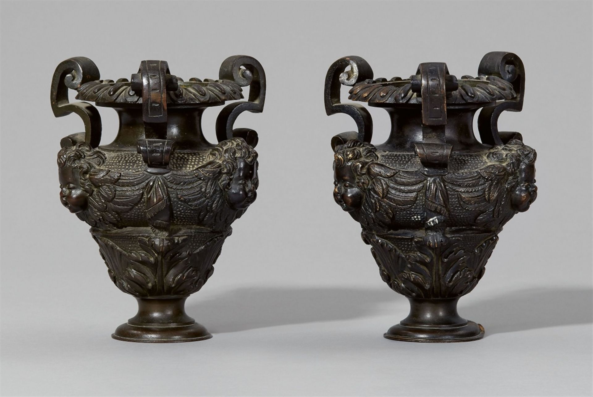 Vases from a pair of andironsCast bronze with dark brown patina. Baluster-form vases with angel's