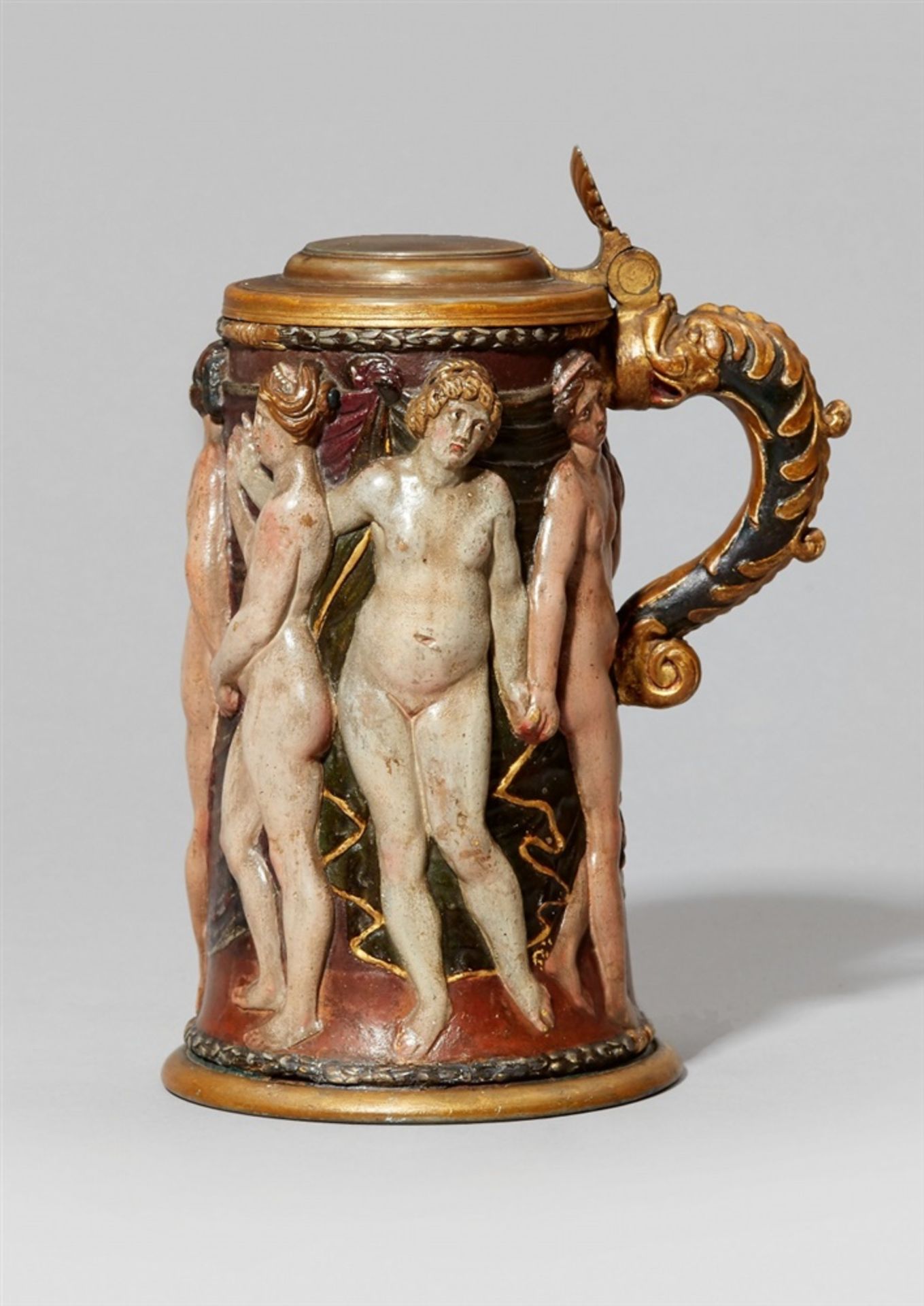 An unusual earthenware tankard with a figural reliefSlightly tapering tankard with green glazed