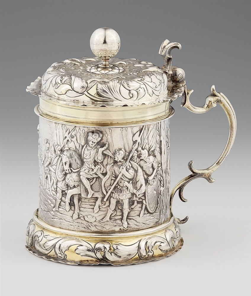 An Augsburg Baroque silver tankardSilver; partly gilded. Parcel-gilt silver tankard with a domed