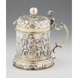 An Augsburg Baroque silver tankardSilver; partly gilded. Parcel-gilt silver tankard with a domed