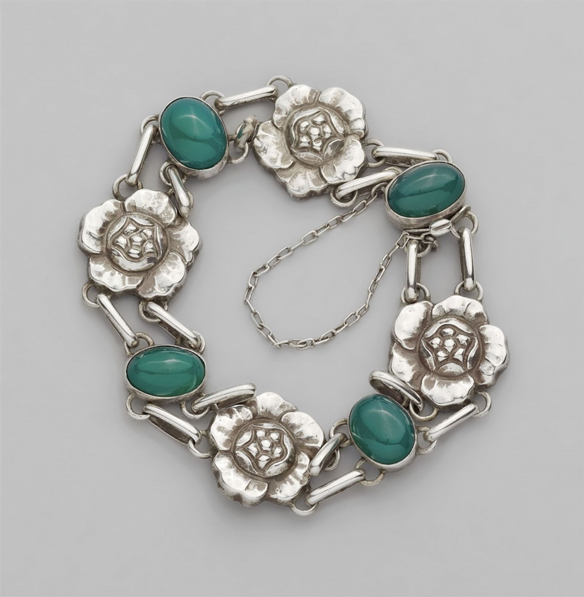 A Jugendstil silver bracelet by Georg Jensen, model no. 12A strand of eight stylised flower links