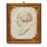 A marble relief plaque with the head of a womanWhite marble on gilt stuccoed wood. Depicting a woman