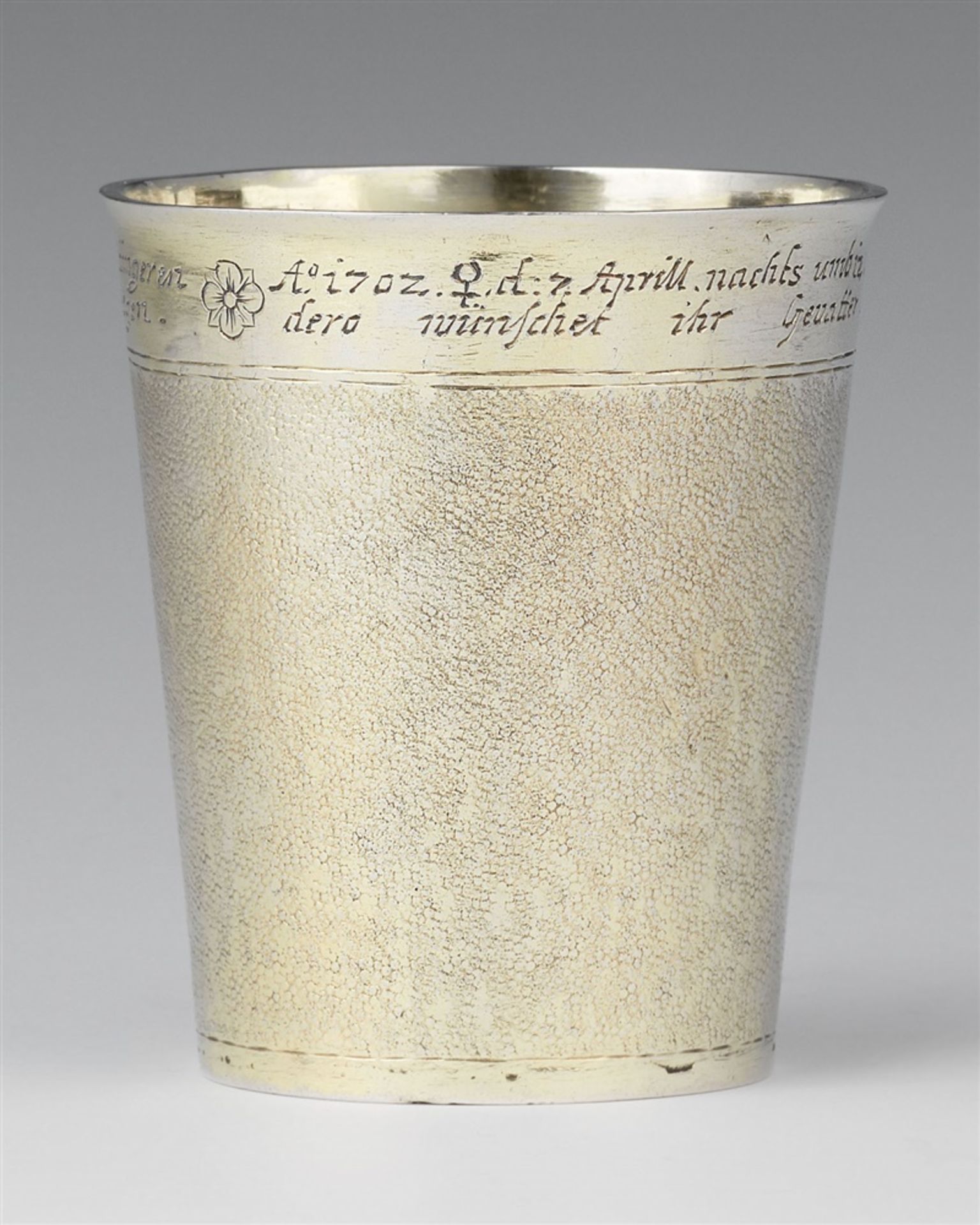 An Ulm silver christening beakerA silver-gilt beaker of tapering cylindrical form with snakeskin