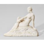 A white marble figure of a seated nudeSigned lower left "C O Battaille". H 51, W 63 cm.César