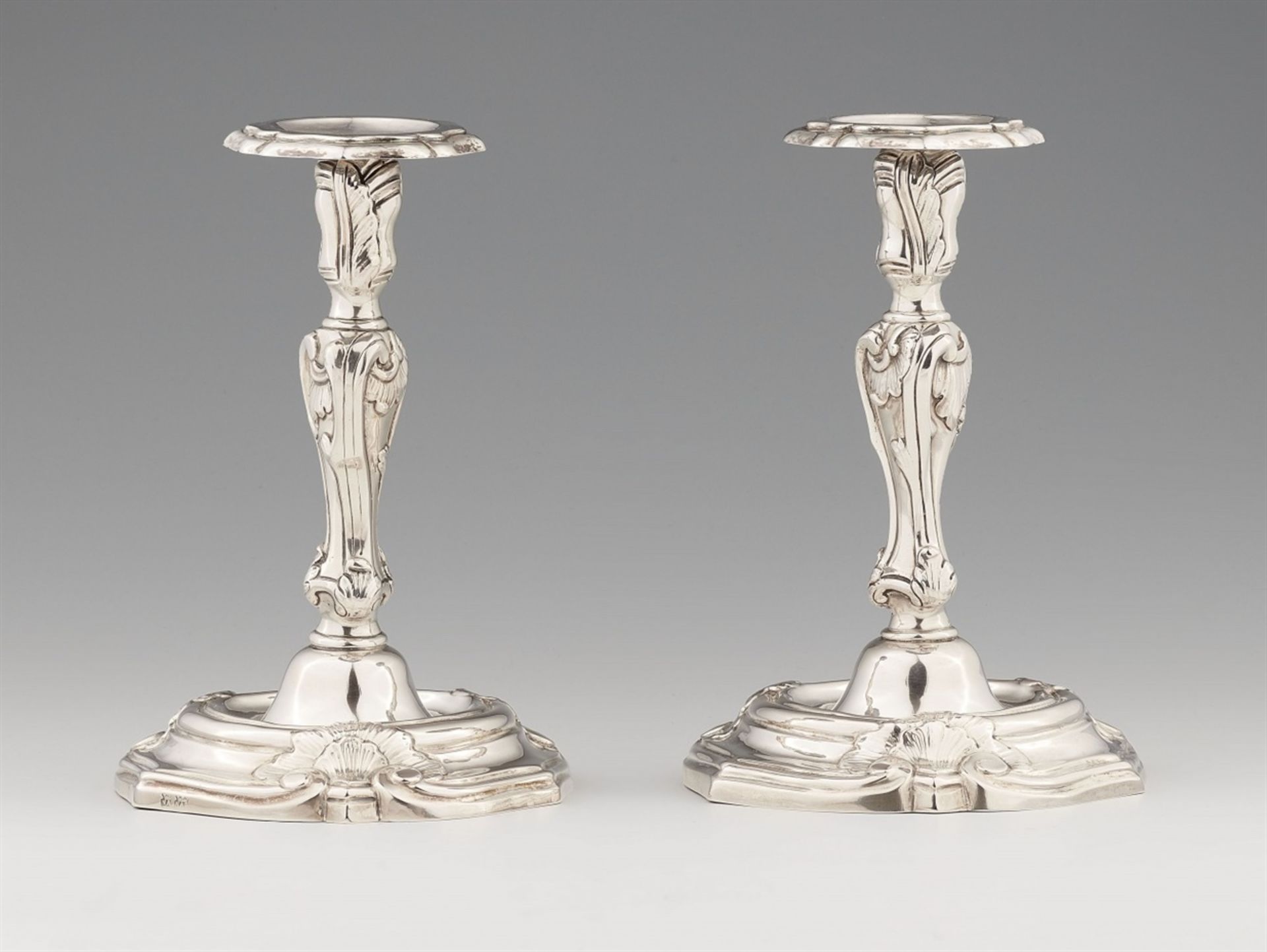 A pair of Italian silver candlesticksBaluster-form shafts with shellwork decor issuing from round