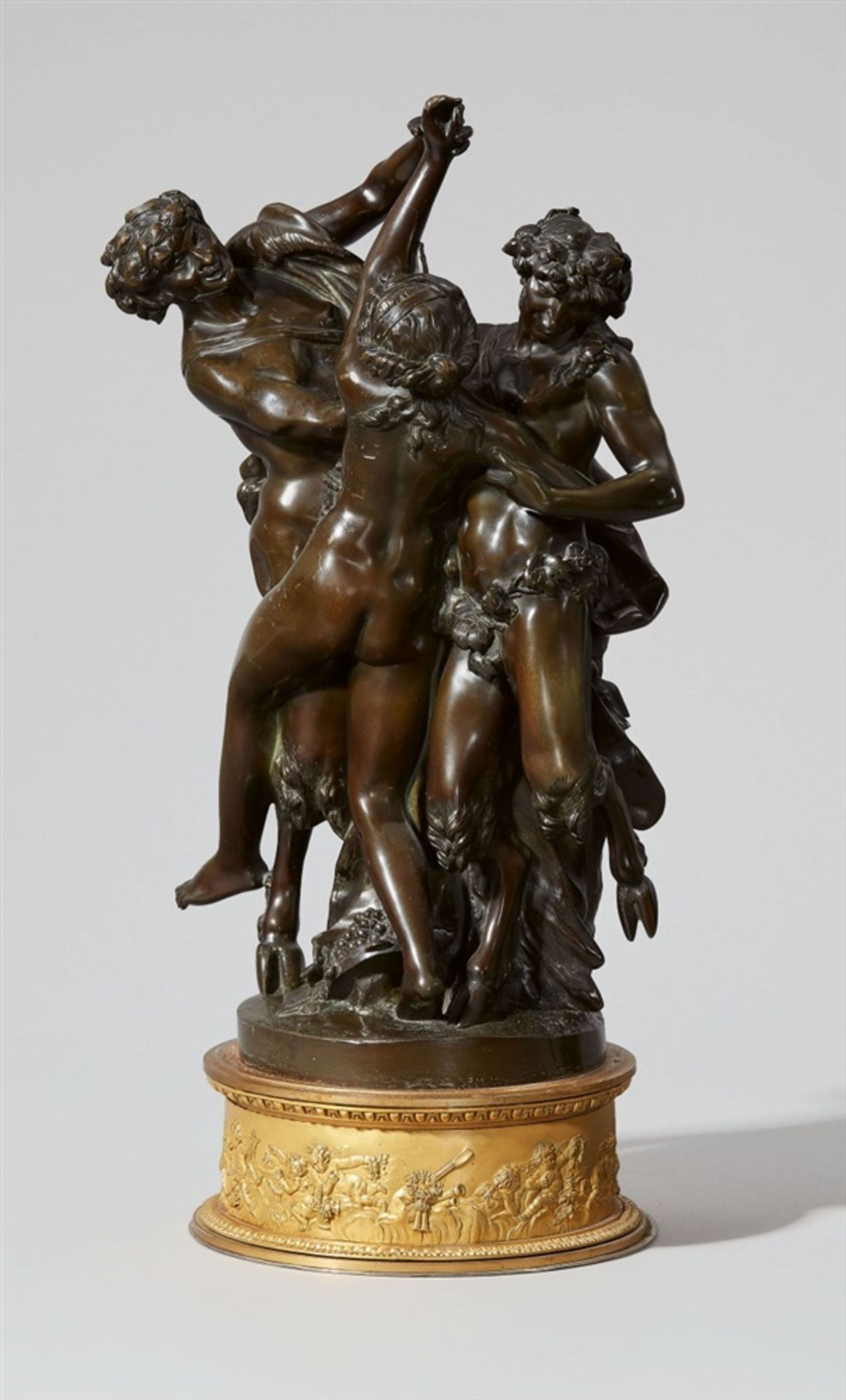 A bronze group with maenads and a satyrCast bronze with golden brown patina and ormolu. Three-figure