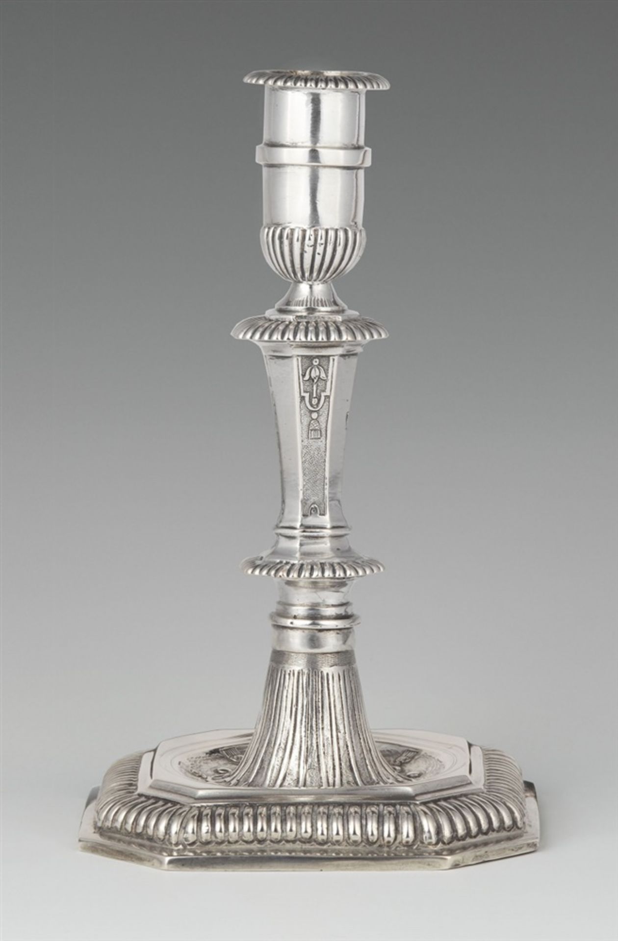 A Hamburg silver candlestickSilver. Square base with gadrooned rim and central hollow with