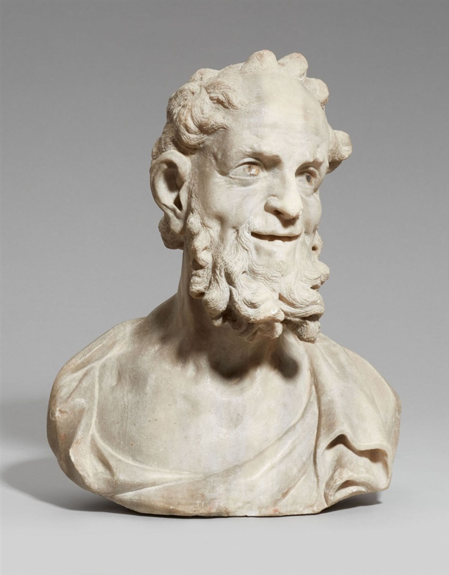 A marble bust of an old manAlmost life-sized pale grey banded marble bust with remnants of