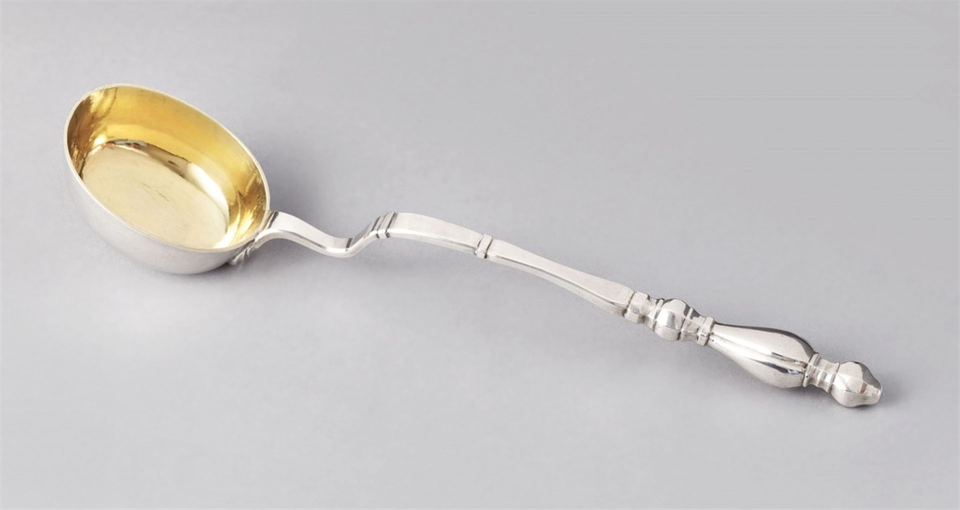 A small Bautzen Baroque silver ladleMoulded handle with a gilt oval bowl. Monogrammed to the