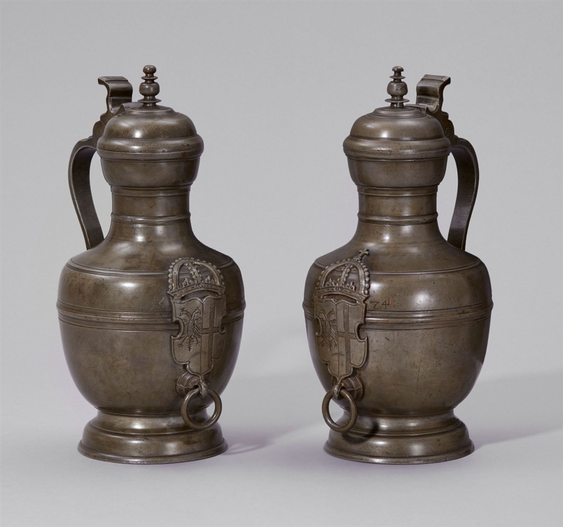 A pair of important jugs made for the council of NeussEngraved pewter pots of solid baluster-form