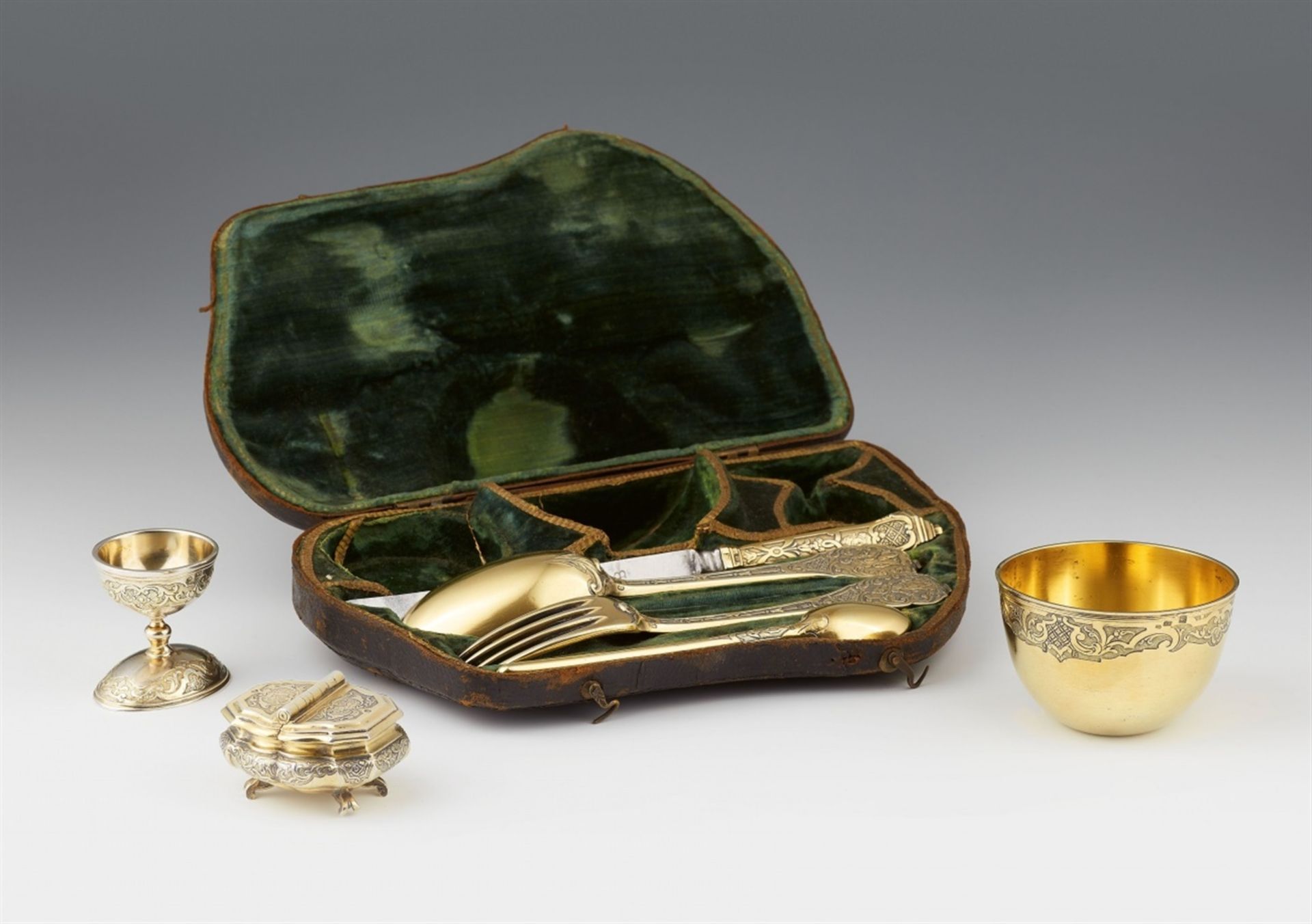 A museum quality Augsburg silver travel dining setSilber; vergoldet. A silver gilt garniture