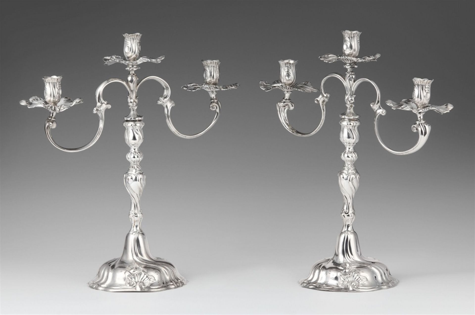 A pair of Braunschweig silver candelabraSilver. Baluster-form shafts with shellwork décor and