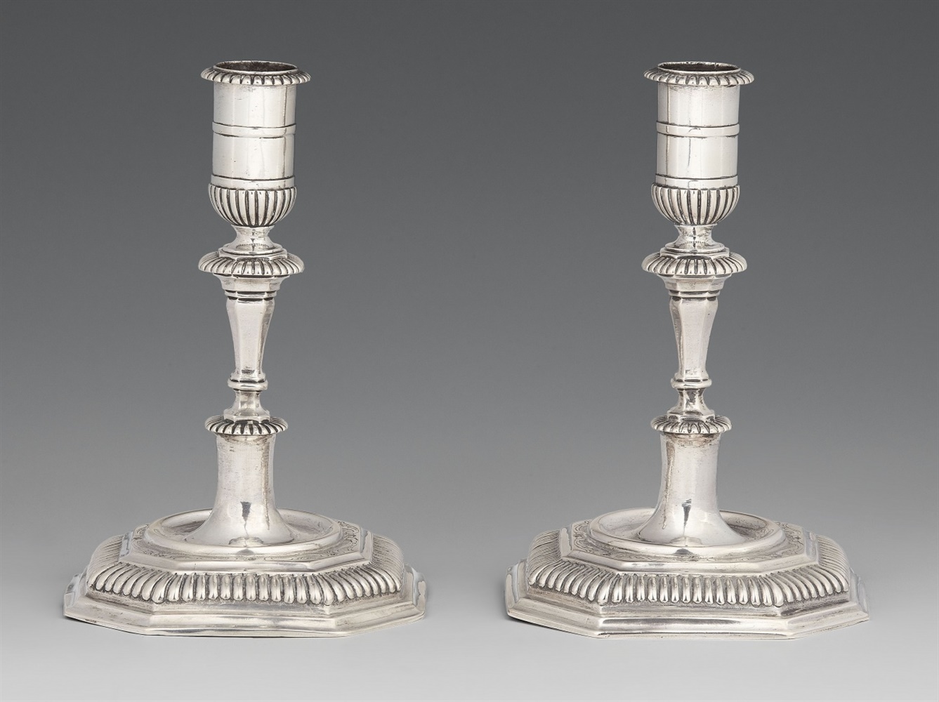 A pair of Halberstadt silver candlesticksSilver. Baluster-form shafts issuing from square