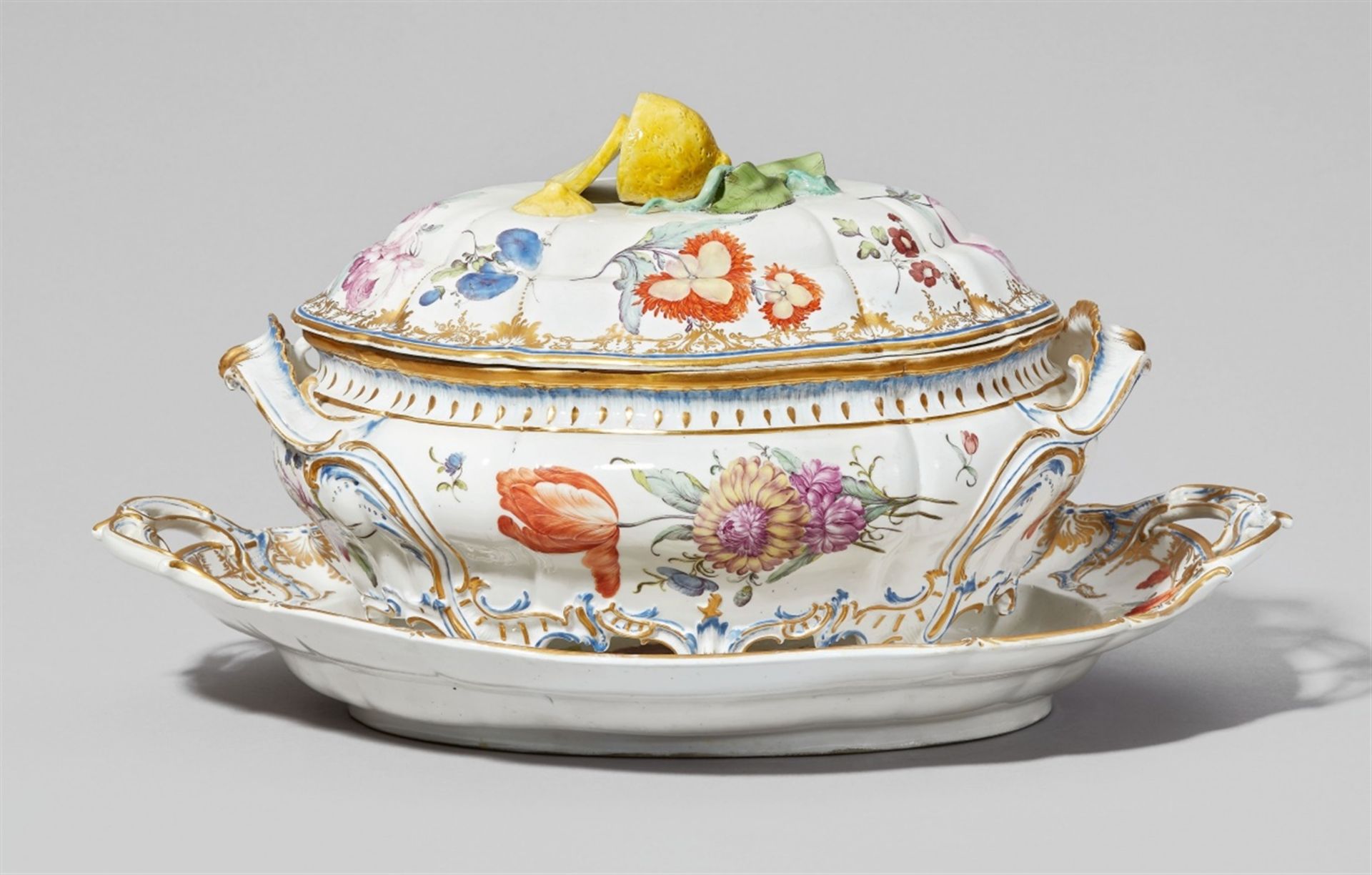 A Nymphenburg porcelain tureen with original standOval tureen on four rocaille supports with