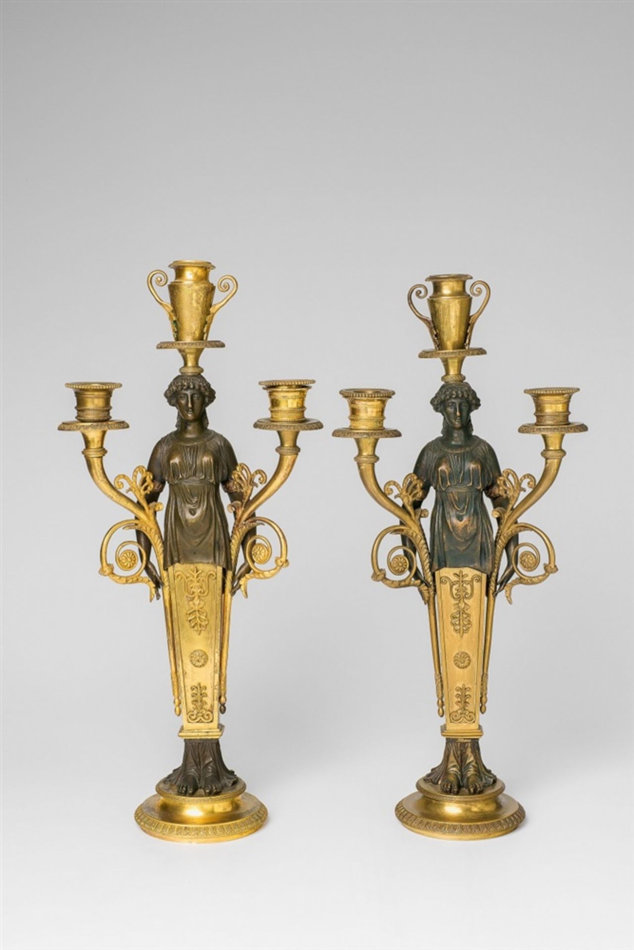 A pair of rare Empire ormolu candelabraCast in several parts and screw-mounted. Three flame