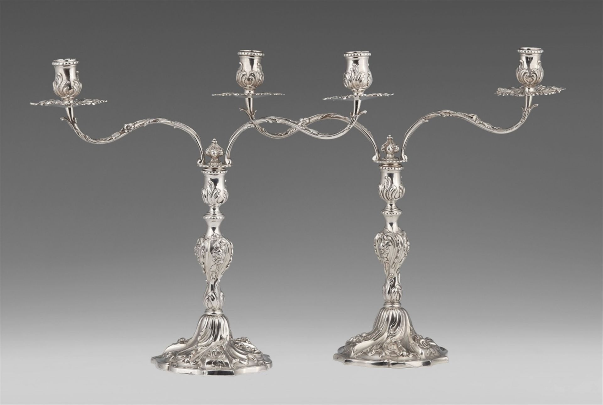 A pair of George II silver candelabraBaluster-form shafts richly decorated with roses and shellwork,