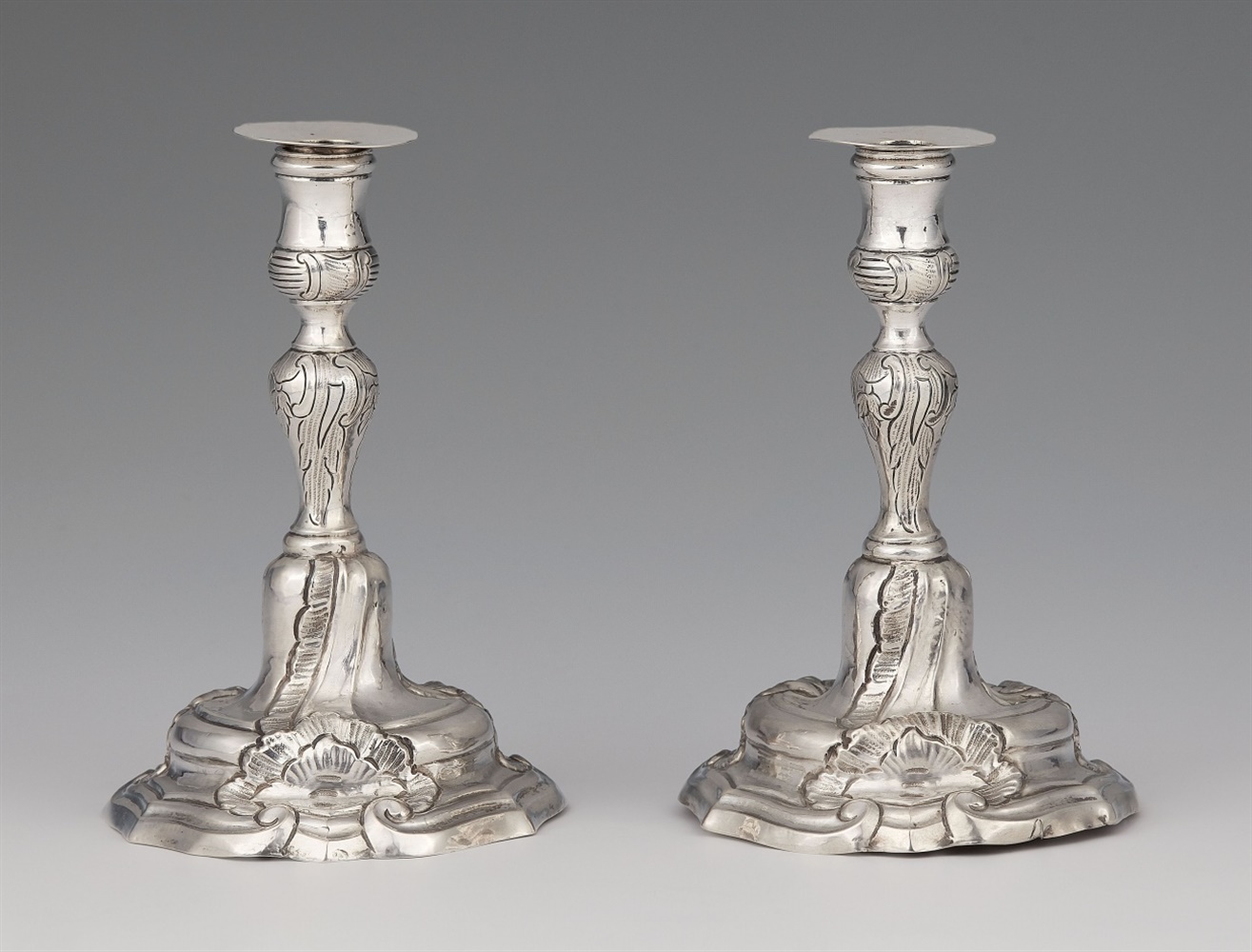 A pair of miniature silver candlesticksSilver Baluster-form shafts with shellwork décor issuing from