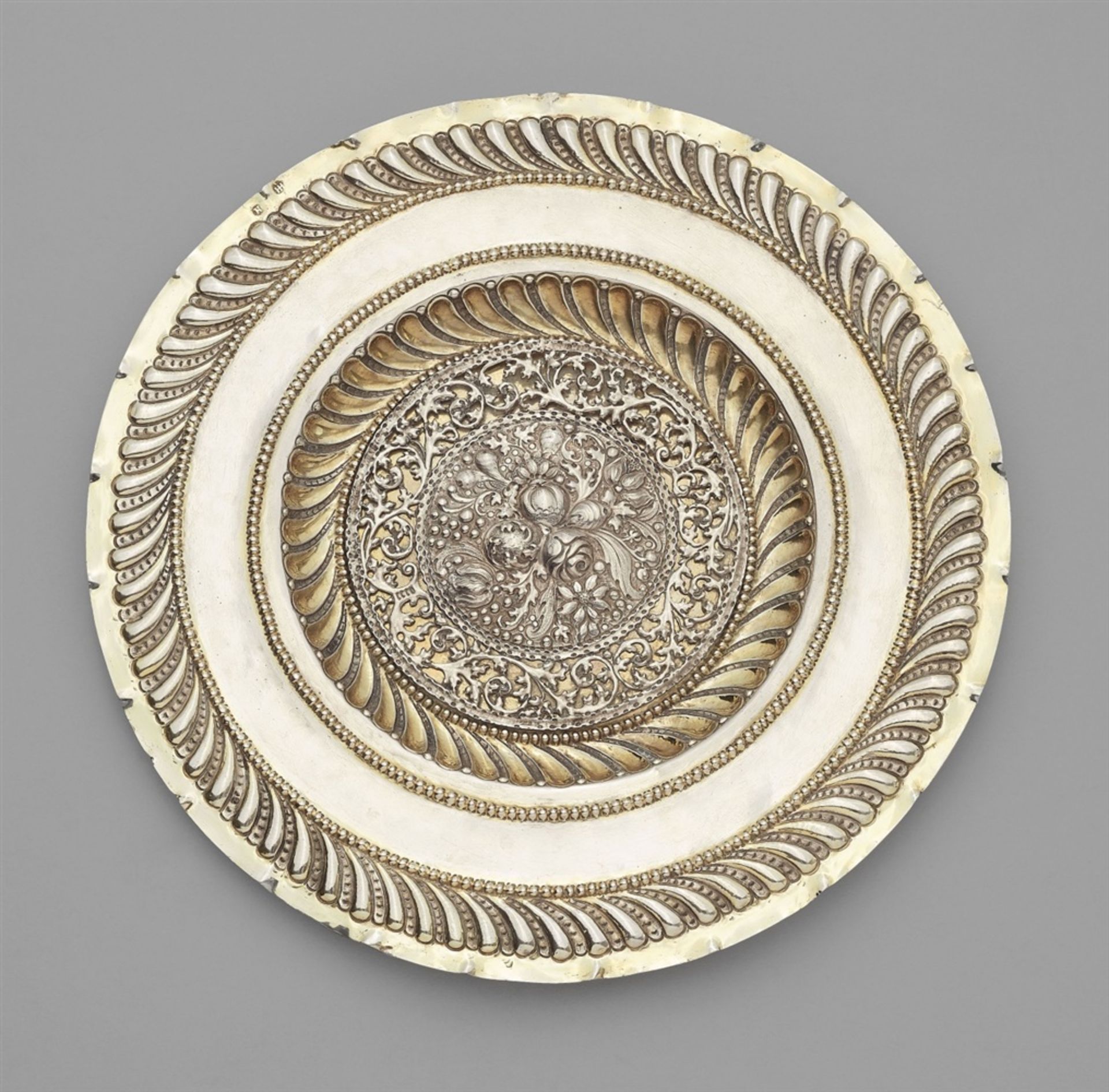 A Nuremberg silver sideboard dishParcel-gilt round silver dish with a pierced embossed plaque