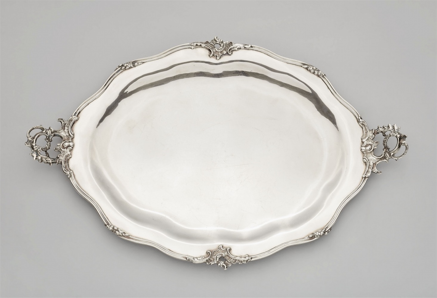 A large Augsburg silver platterA moulded silver platter with rocaille handles, the narrow rim with