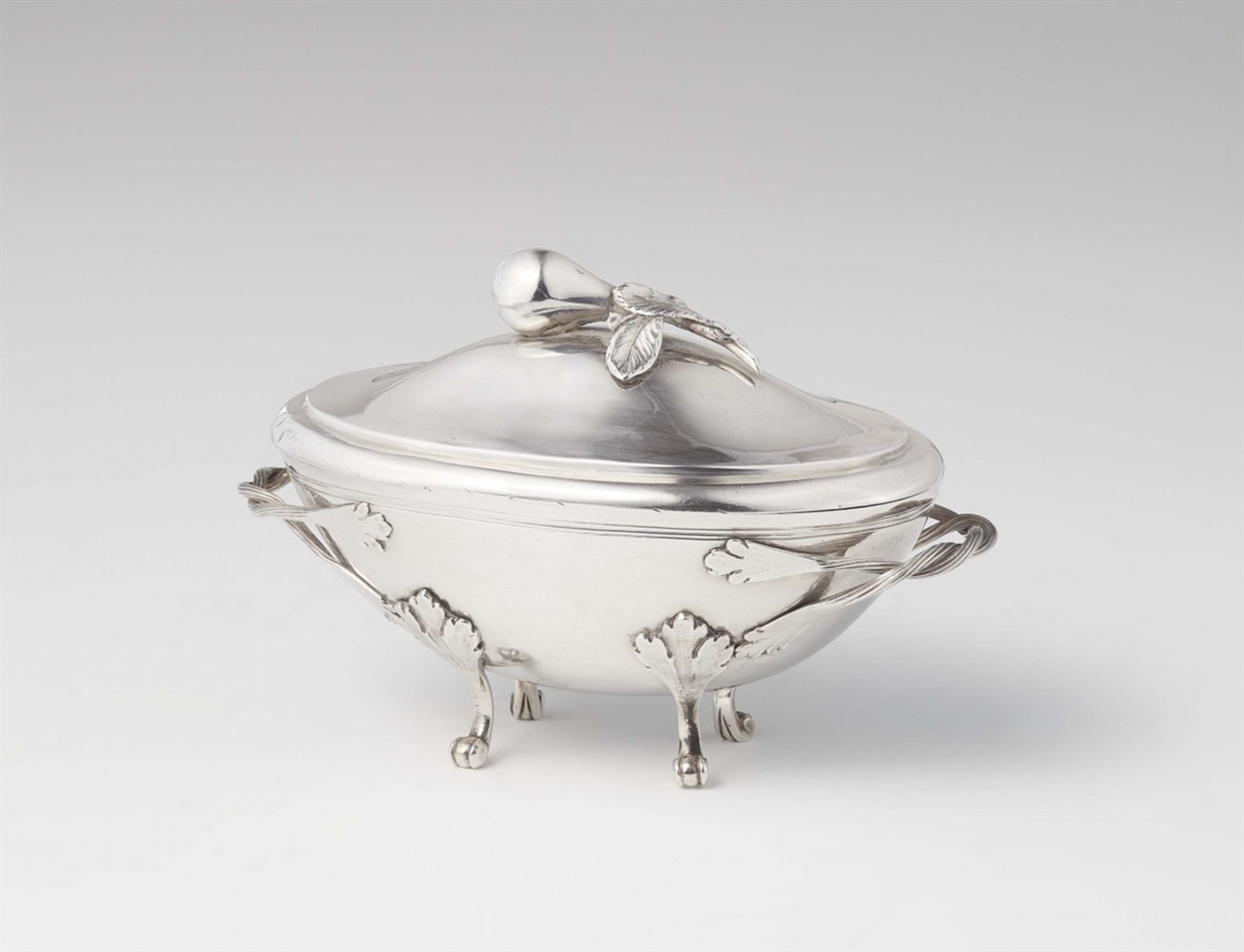 A rare Italian silver sugar boxInterior gilt oval box resting on four supports, the domed slip lid
