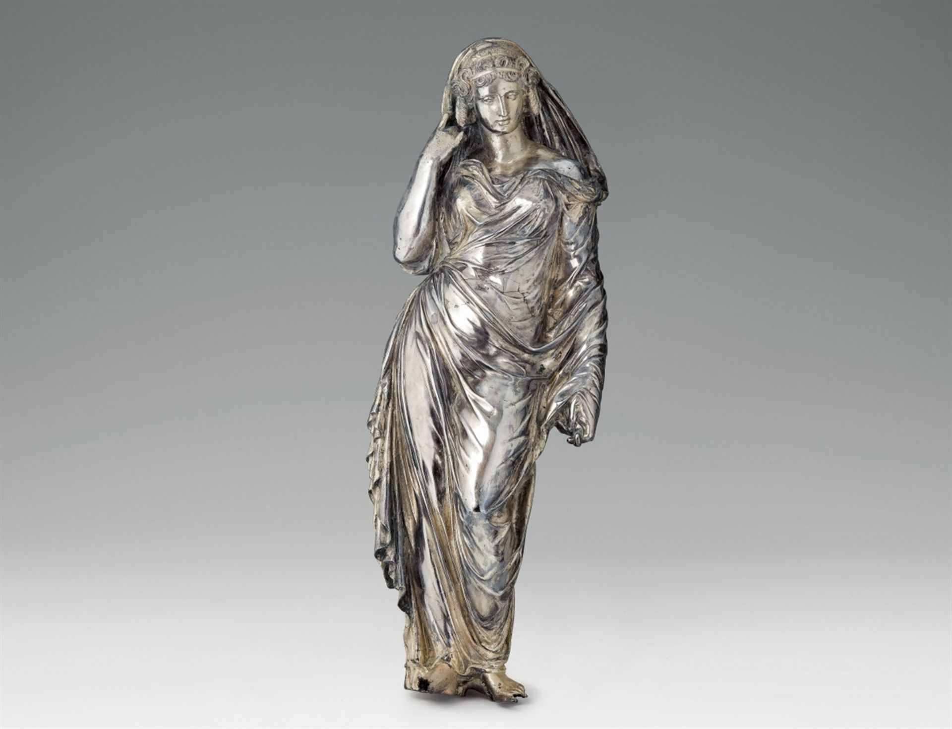 A large silver standing figure of a VestalLosses to the area around the feet, a formerly attached