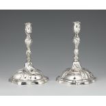 A pair of Augsburg silver candlesticksSilver Baluster-form shafts with draperies issuing from round,