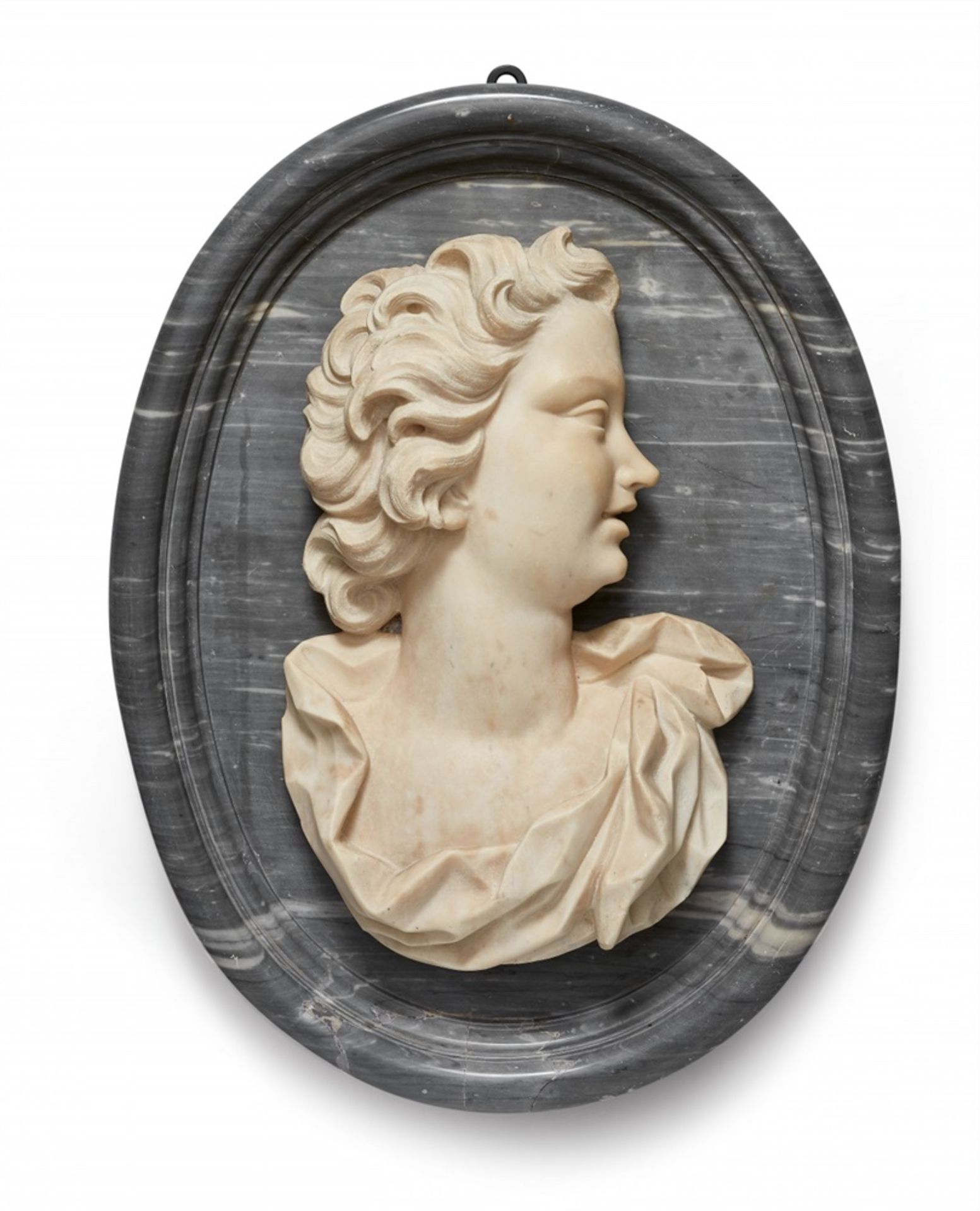 An androgynous relief bustWhite and pale marble bust of a figure with flowing locks facing right