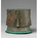 An early Islamic mortarCast and chased bronze with sintered remnants of red pigment. Originally of