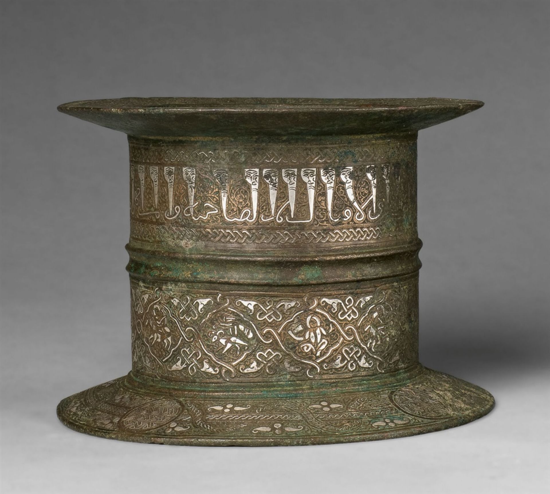 An important Islamic mortarChased cast bronze with silver and copper damascening. Of cylindrical