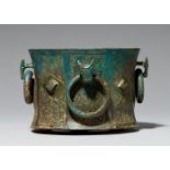 A rare mortar with four animal head handlesChased cast bronze with brownish green patina. Of