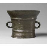 An early English mortar monogrammed GWECast bronze with slightly dull brown patina. Tapering form
