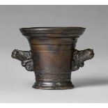 A small mortar with lion handlesCast bronze with golden brown patina. The handles formed as two