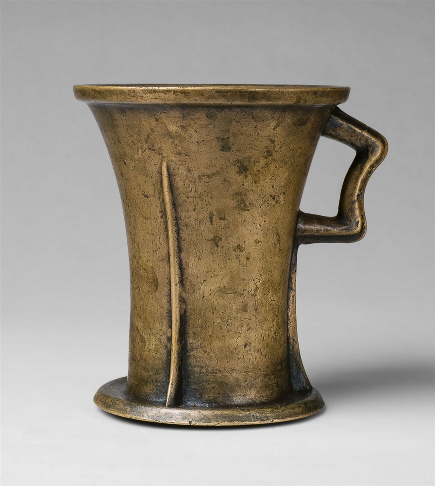 A Gothic one-handled mortarCast bronze with slightly mottled golden brown patina. Tapering form on a