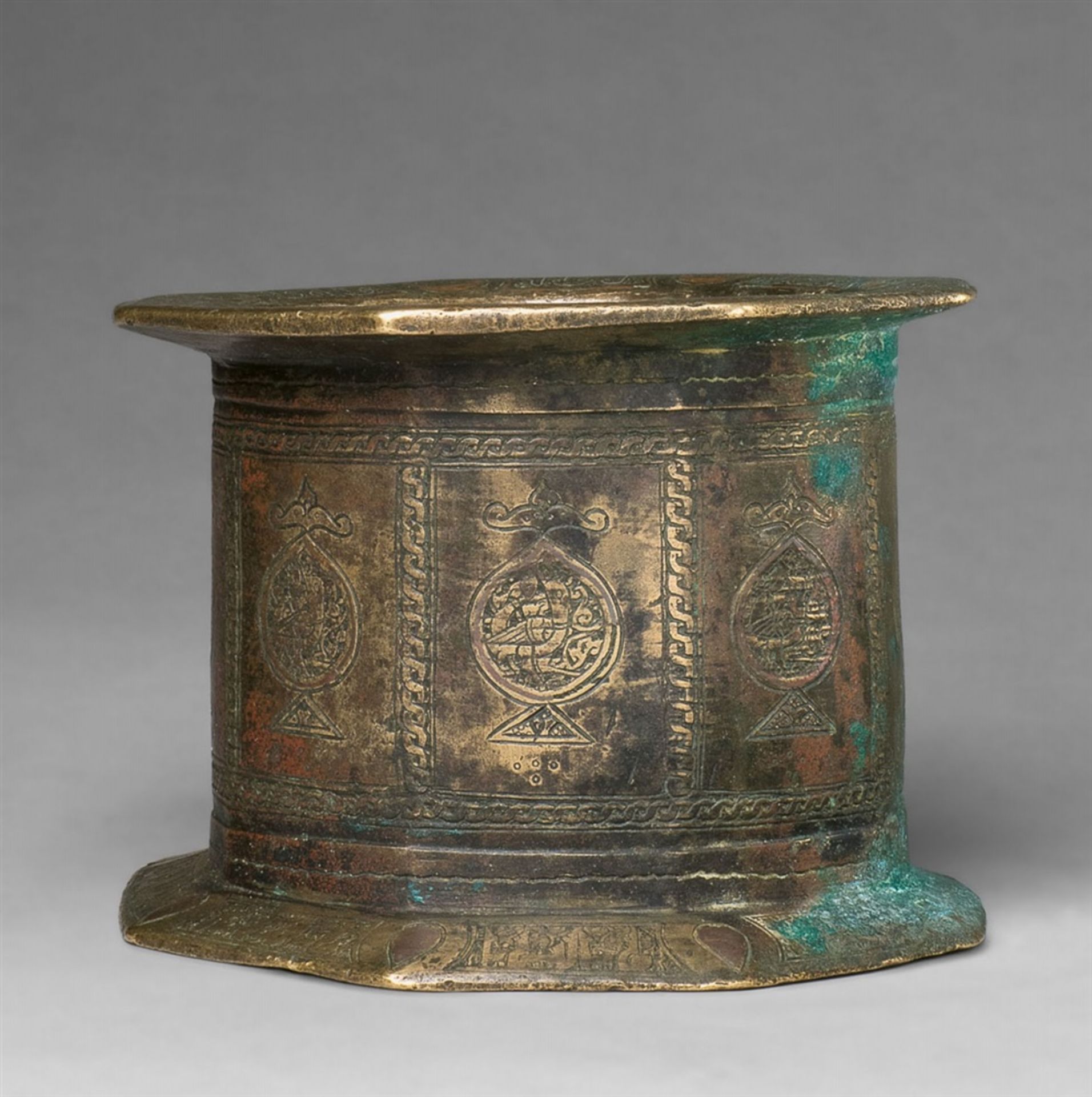 An important Islamic mortarChased cast bronze with copper and silver damascening and remnants of red