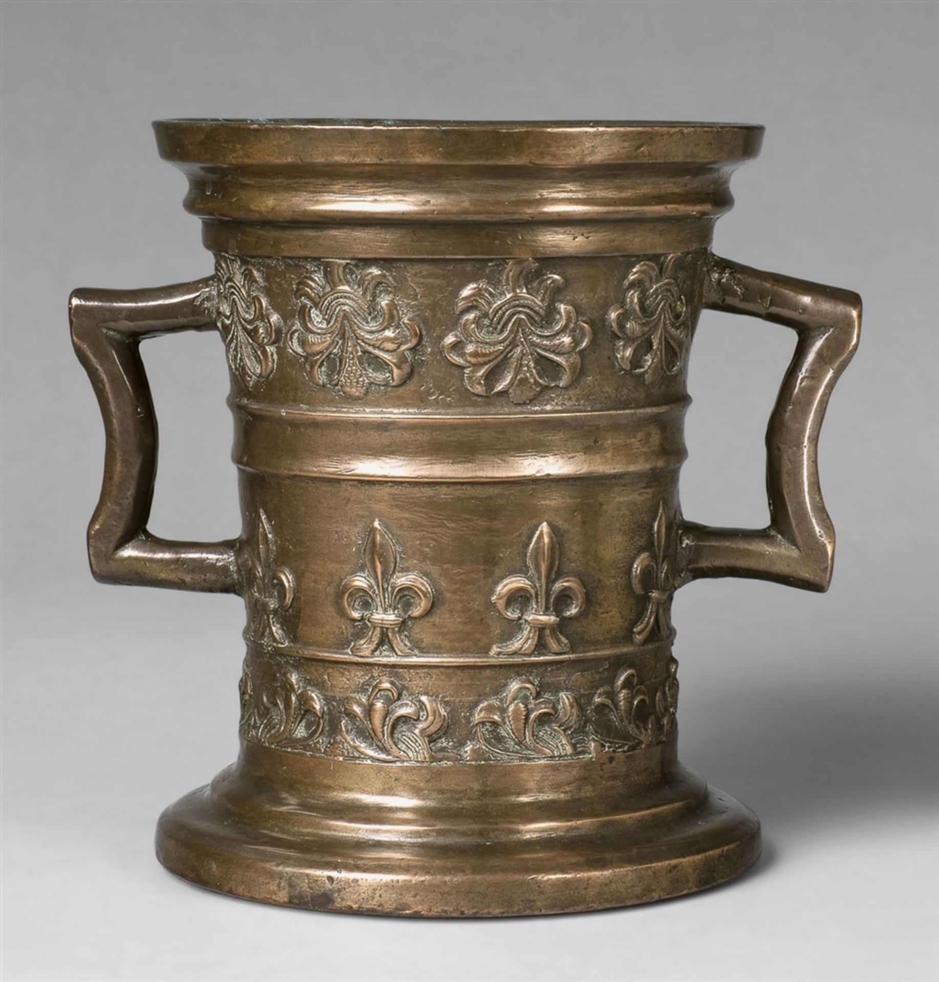 A rare mortar with fleur-de-lys motifsThick golden brown cast bronze with polished natural patina.