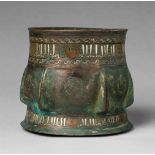 An Islamic mortar with bird motifsChased bronze with silver and copper damascening and remnants of