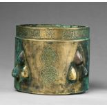 An Islamic mortarYellowish golden chased bronze. Cylindrical form with slightly waisted upper rim.