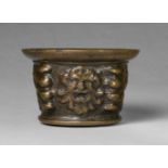 A mortar with mascaron decorThick cast bronze with natural patina. Of squat, tapering form with a