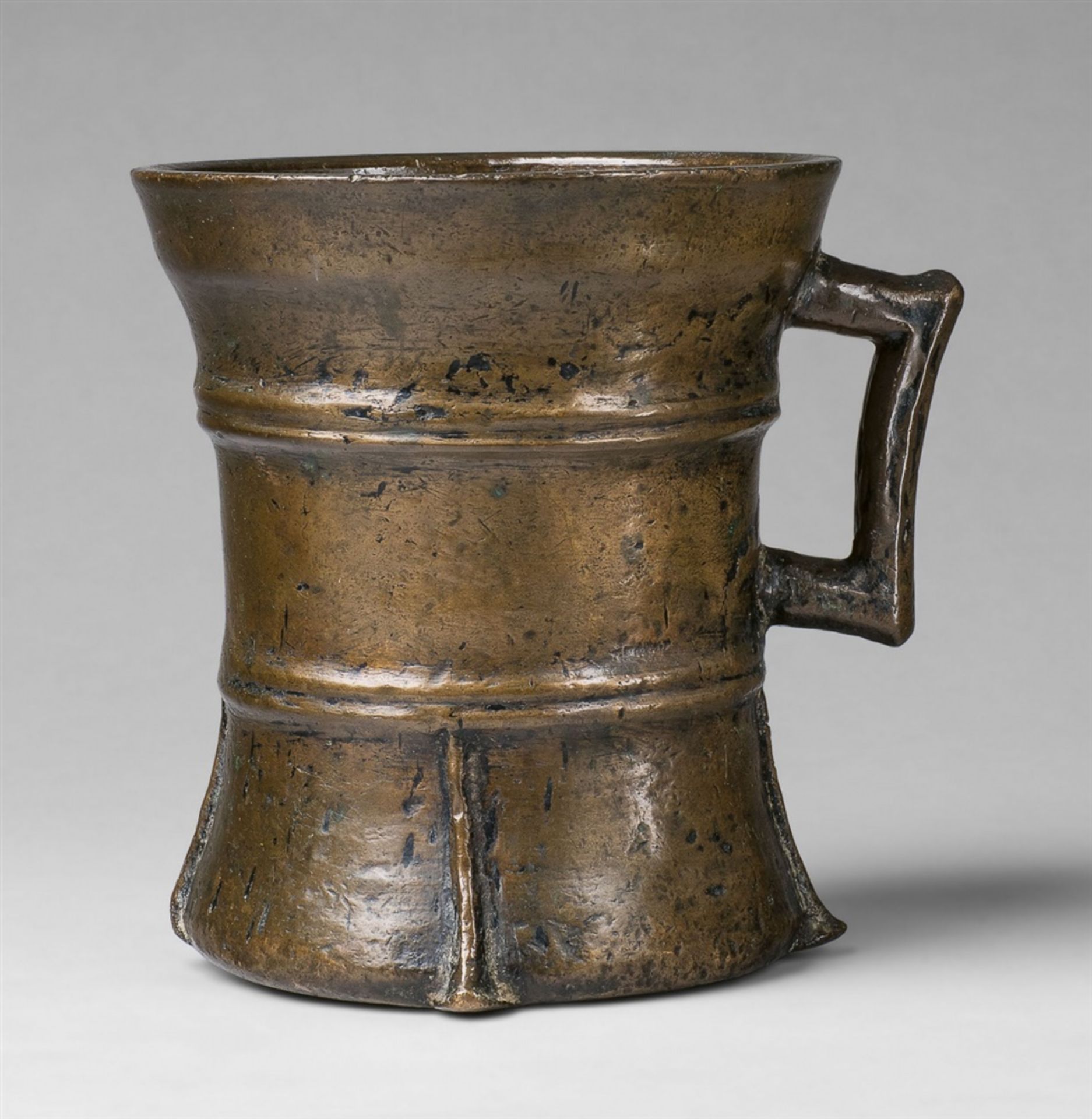 A large Gothic one-handled mortarCast bronze with slightly mottled golden brown patina. With two